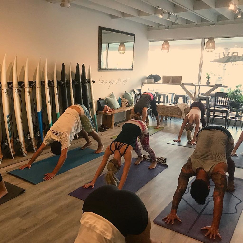 Group does yoga in a coffee shop