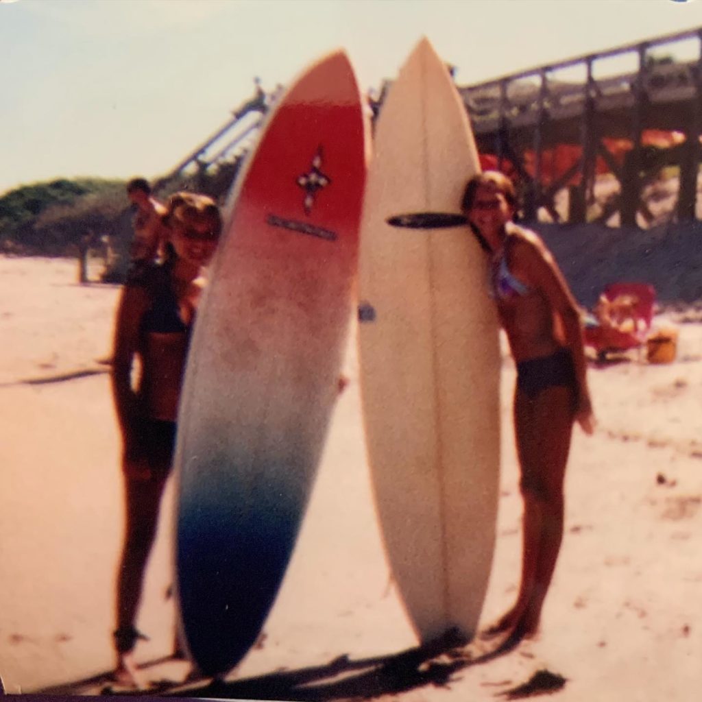 Teen surfers hold boards