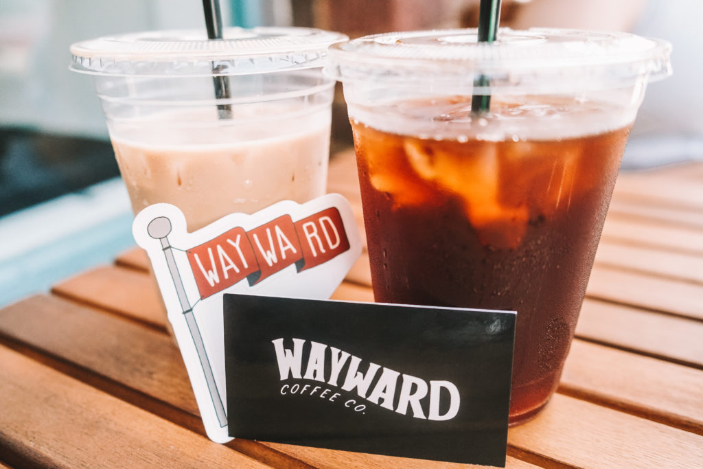 Wayward coffee business card next to iced coffee