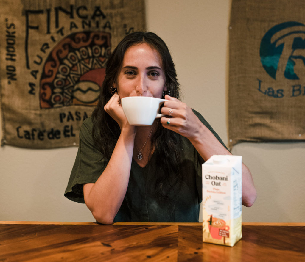 woman drinking oat milk latte