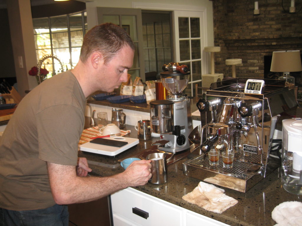 Tom using coffee and espresso equipment in a kitchen