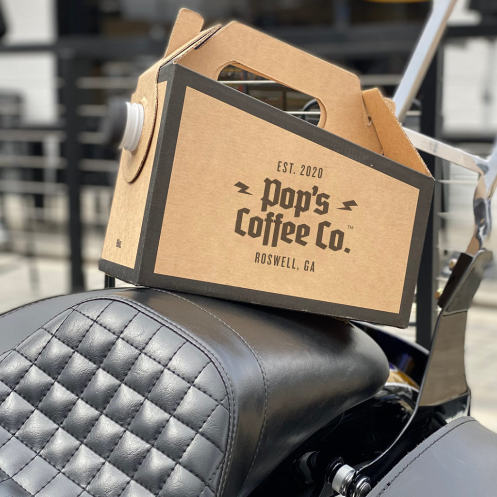 Pop's Coffee Co to-go coffee carafe on motorcycle seat