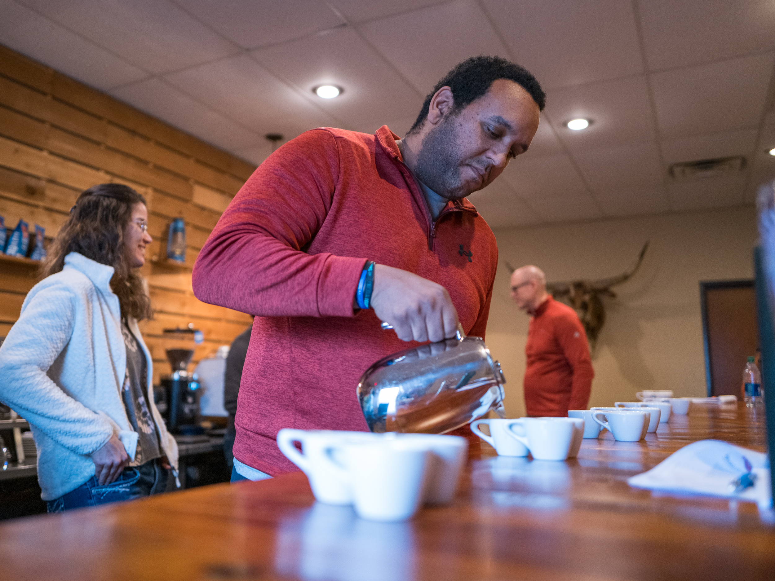 A man pours coffee at Texas Coffee School.