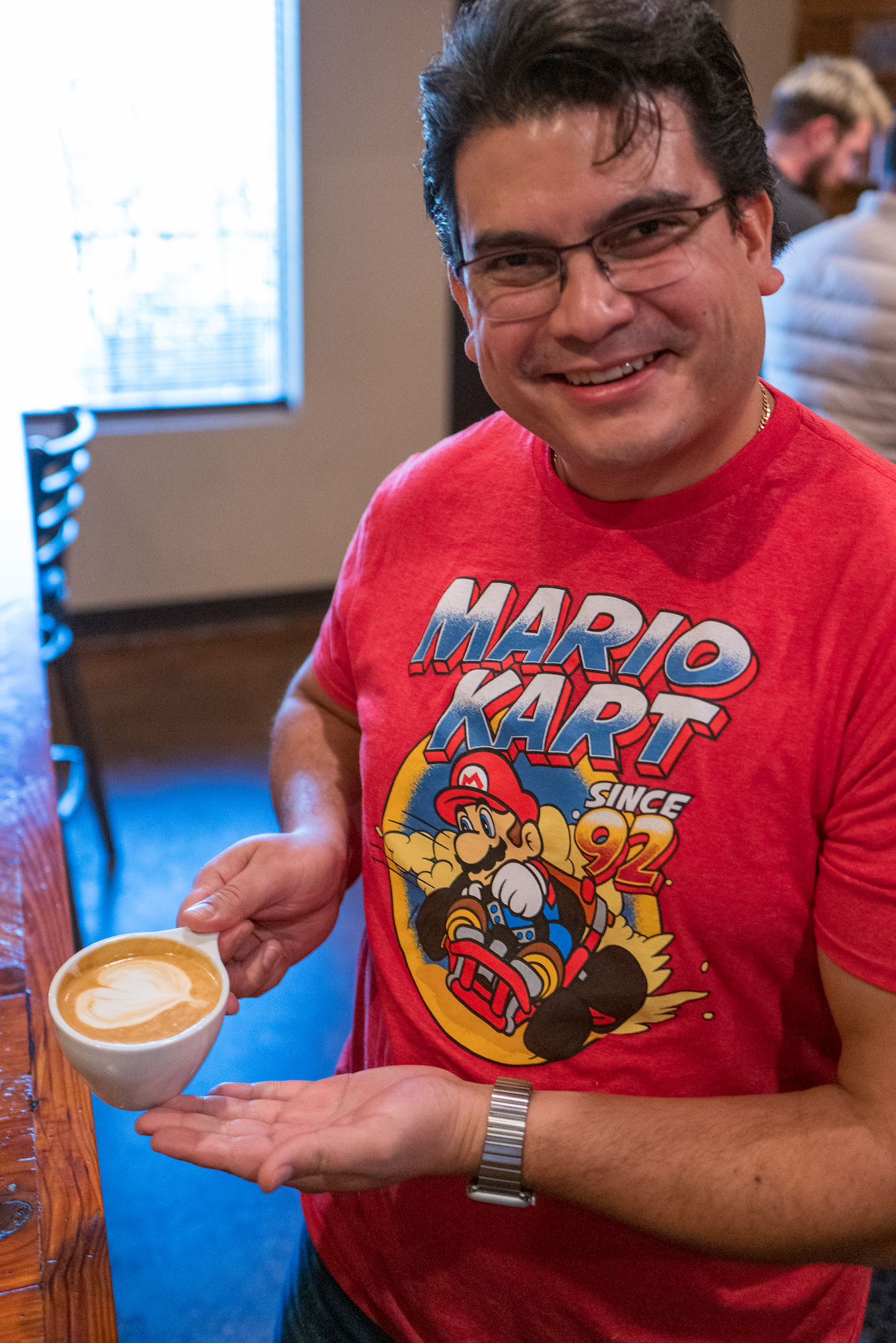 A man holds coffee at Texas Coffee School.
