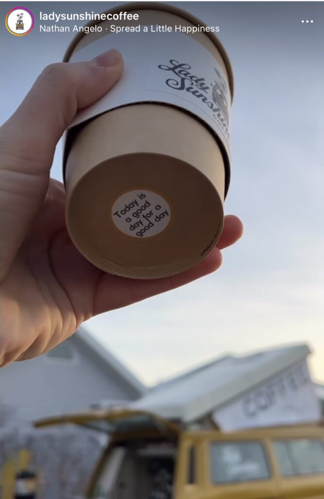 Coffee cup with sticker that says, "Its a good day to have a good day." 