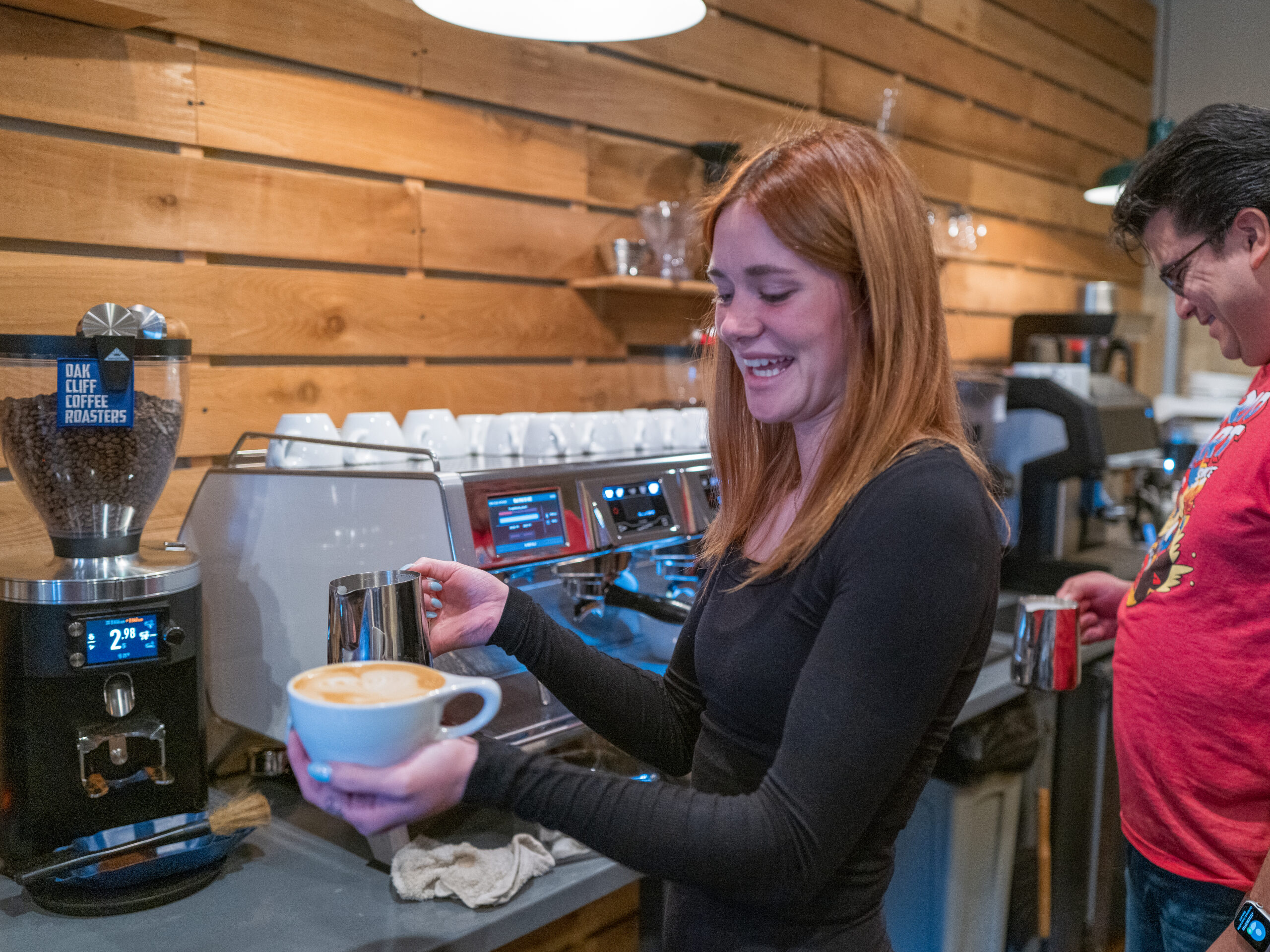 Woman holding latte in Texas Coffee School's 3-Day Coffee Business Master Class.