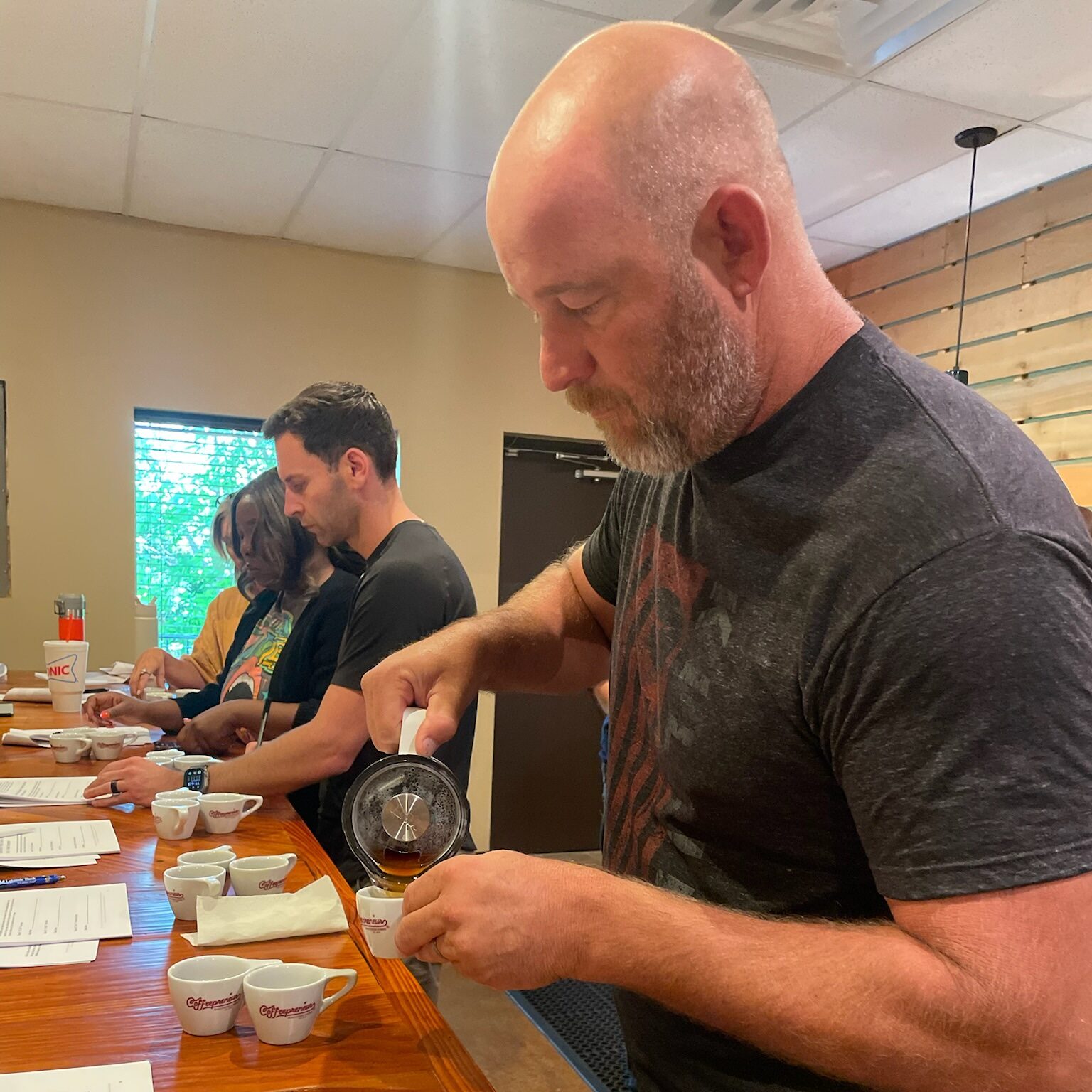 A student pours coffee at Texas Coffee School.