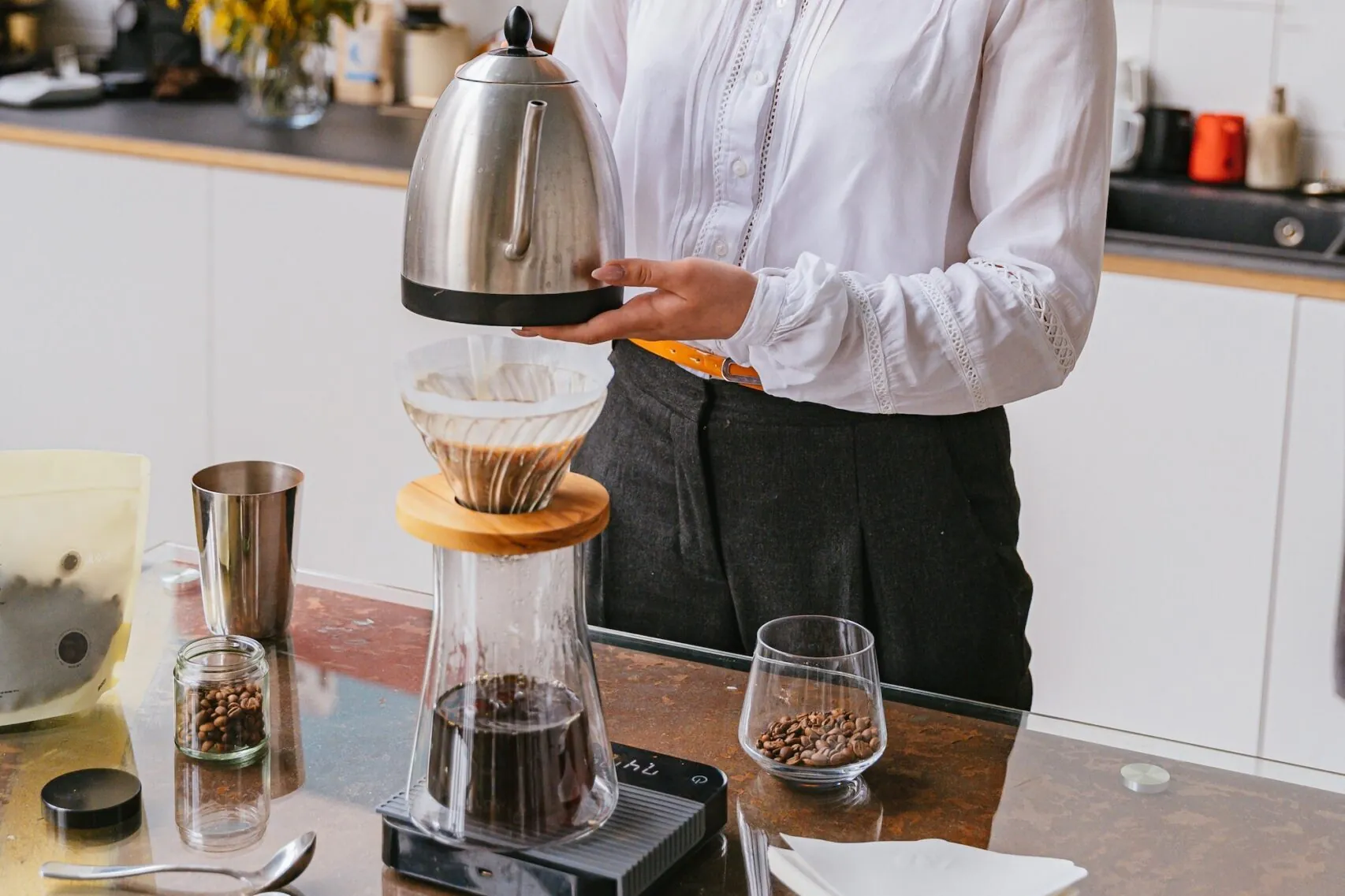 A barista makes pour over coffee.