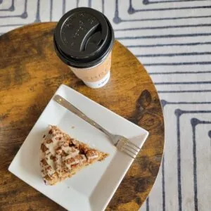 A pastry and coffee on a table.