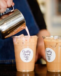 Barista pours coffee at Country Charm Coffee.