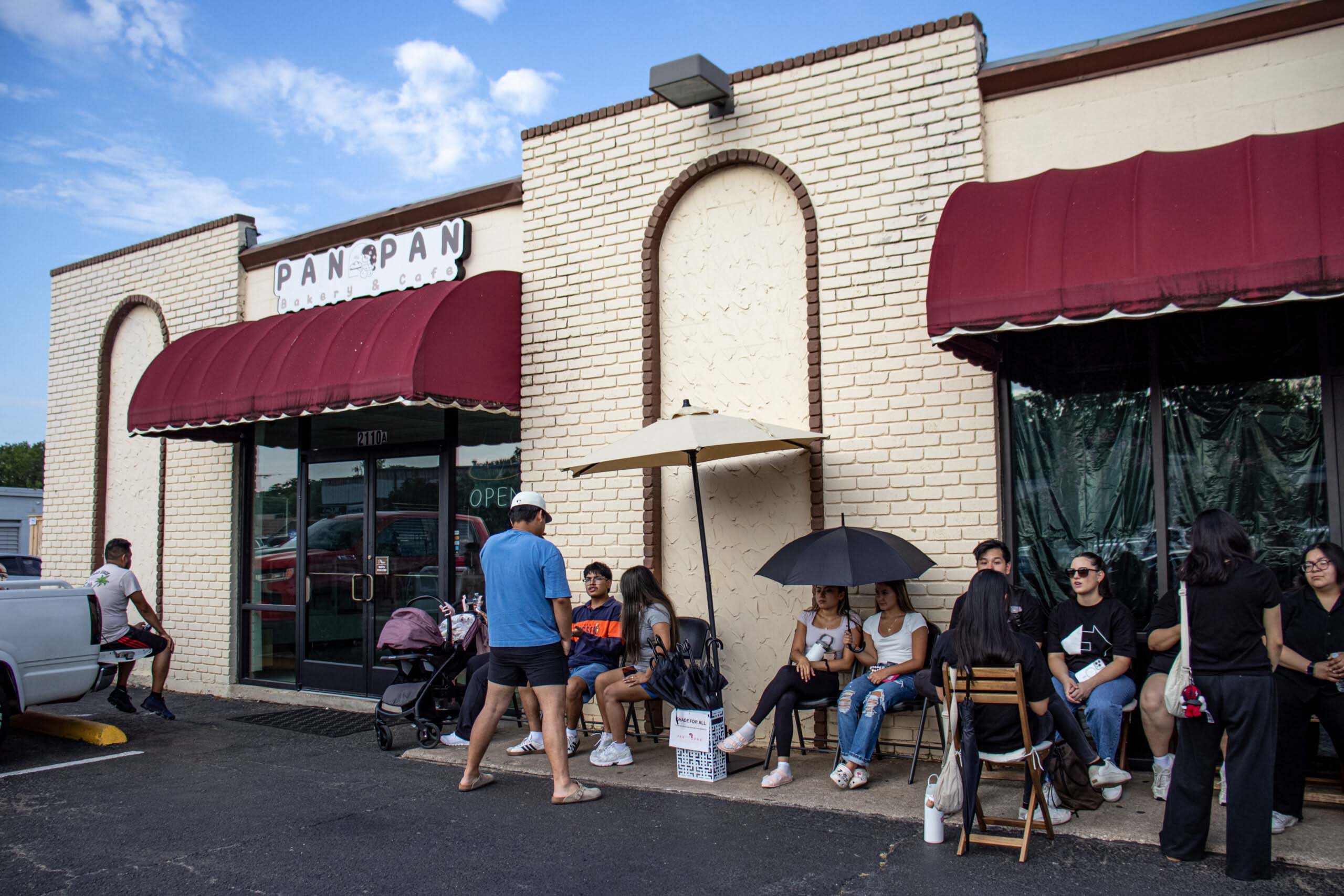 A line of people wait outside Pan Pan Bakery Cafe, Mexican-Japanese fusion bakery.