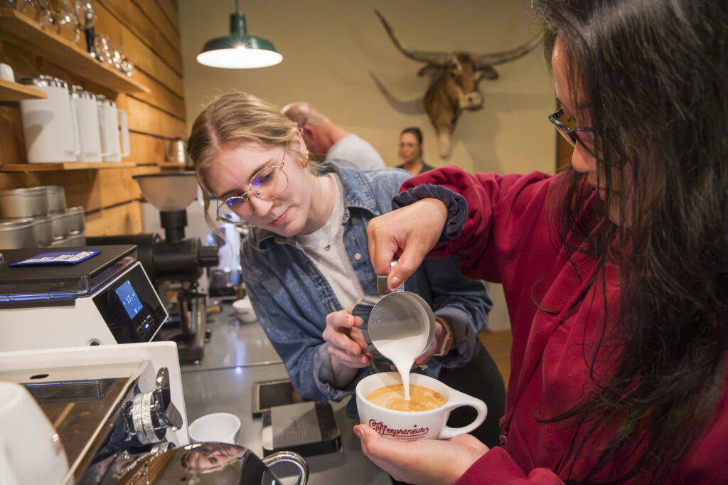 Texas Coffee School educator and student doing hands on barista training